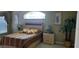 Comfortable bedroom featuring a large bed, soft lighting, and tasteful decor for a relaxing retreat at 18412 Oriole St, Lutz, FL 33558