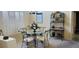Stylish dining room featuring a glass table with iron chairs, complemented by natural light, and neutral decor at 18412 Oriole St, Lutz, FL 33558