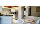 Bright kitchen with stainless steel appliances, white cabinets, black countertops, and tiled flooring, plus an eat-in area at 18412 Oriole St, Lutz, FL 33558