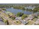 Aerial view of lakeside property with a beautiful waterfront view, surrounded by lush trees in a quiet neighborhood at 1894 Union St, Clearwater, FL 33763