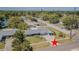 Aerial view of a home, showing its location in a quiet neighborhood with mature trees and nearby lake at 1894 Union St, Clearwater, FL 33763