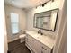 Updated bathroom with a granite countertop, black hardware, and a modern mirror at 1894 Union St, Clearwater, FL 33763