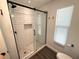 Modern bathroom with a glass-enclosed shower featuring subway tile and stylish fixtures at 1894 Union St, Clearwater, FL 33763
