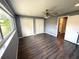 Bedroom with wood floors, neutral walls, ceiling fan, and double door closets at 1894 Union St, Clearwater, FL 33763
