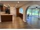 Spacious kitchen with wood cabinets, granite counters, and an open layout to a screened lanai at 1894 Union St, Clearwater, FL 33763