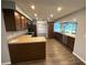 Open-concept kitchen featuring wood cabinetry, granite countertops, and stainless steel appliances at 1894 Union St, Clearwater, FL 33763