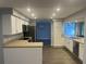 This well-lit kitchen features stainless steel appliances, white cabinets, and flows into the dining area at 1894 Union St, Clearwater, FL 33763