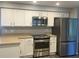 This kitchen features stainless steel appliances, bright cabinets, and ample counter space for cooking at 1894 Union St, Clearwater, FL 33763