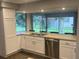 Open kitchen view with stainless steel appliances and a picture window overlooking backyard at 1894 Union St, Clearwater, FL 33763