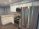 Updated kitchen with stainless steel appliances, white cabinets, and modern finishes at 1894 Union St, Clearwater, FL 33763