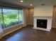 Bright living room featuring a brick fireplace and large window offering scenic views at 1894 Union St, Clearwater, FL 33763