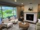 Cozy living room featuring a brick fireplace, large windows, and comfortable seating at 1894 Union St, Clearwater, FL 33763