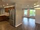 Open living space adjacent to kitchen, with hardwood floors, stainless appliances, and ample natural light at 1894 Union St, Clearwater, FL 33763