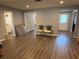 An open living room features wood-look floors and accent chairs in front of doorways and a window at 1894 Union St, Clearwater, FL 33763