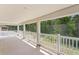 A covered back porch overlooks a lush green space, offering serene views and shade at 20123 Bay Cedar Ave, Tampa, FL 33647
