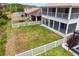 Backyard aerial showcasing a spacious lawn, screened patio, white fence, and outdoor space at 20123 Bay Cedar Ave, Tampa, FL 33647