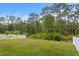 Expansive backyard featuring a well-maintained lawn and a white fence bordering natural greenery at 20123 Bay Cedar Ave, Tampa, FL 33647