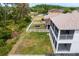 Aerial of the backyard with a trampoline and surrounding greenery near a screened patio at 20123 Bay Cedar Ave, Tampa, FL 33647