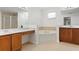 Bathroom featuring double sinks, a soaking tub, and neutral tile at 20123 Bay Cedar Ave, Tampa, FL 33647