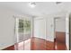 Bedroom featuring hardwood floors, white walls, a large closet, and sliding glass doors to the balcony at 20123 Bay Cedar Ave, Tampa, FL 33647