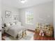 Cozy bedroom with hardwood flooring and a fun moon and stars decor theme at 20123 Bay Cedar Ave, Tampa, FL 33647
