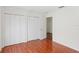 Bedroom featuring a window, wooden flooring, closet, and interior door at 20123 Bay Cedar Ave, Tampa, FL 33647