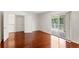 Bedroom featuring hardwood floors, white walls, and sliding glass doors to the balcony at 20123 Bay Cedar Ave, Tampa, FL 33647