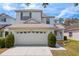 Charming two-story home featuring a two-car garage, manicured lawn and front garden at 20123 Bay Cedar Ave, Tampa, FL 33647