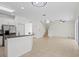 Spacious living room featuring an open floorplan with staircase and kitchen with breakfast bar at 20123 Bay Cedar Ave, Tampa, FL 33647