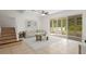 Comfortable living room with tiled floors, stairs, and access to an outdoor living space at 20123 Bay Cedar Ave, Tampa, FL 33647