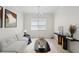 Bright living room with neutral colors, contemporary furniture, and a large window with natural light at 20123 Bay Cedar Ave, Tampa, FL 33647