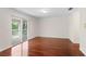 Bright living room with hardwood floors and sliding glass doors to the balcony at 20123 Bay Cedar Ave, Tampa, FL 33647