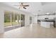 Bright living room showcasing an open floor plan, screened lanai, and modern tile flooring at 20123 Bay Cedar Ave, Tampa, FL 33647