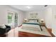 Cozy bedroom featuring wood floors, neutral tones, with lanai access at 20123 Bay Cedar Ave, Tampa, FL 33647