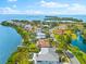 Expansive aerial view of waterfront homes, showcasing their prime location with water access and lush surroundings at 2081 Pointe Alexis Dr, Tarpon Springs, FL 34689