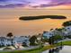 Breathtaking aerial view of bayfront homes with manicured lawns and picturesque water views at 2081 Pointe Alexis Dr, Tarpon Springs, FL 34689