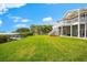 Expansive backyard with a lush lawn, private dock, and scenic water views, perfect for relaxation at 2081 Pointe Alexis Dr, Tarpon Springs, FL 34689