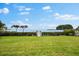 Beautiful backyard with a private dock, meticulously landscaped lawn, and mature trees at 2081 Pointe Alexis Dr, Tarpon Springs, FL 34689
