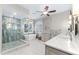 Modern bathroom featuring dual sinks, standalone tub, walk-in shower, and neutral color palette at 2081 Pointe Alexis Dr, Tarpon Springs, FL 34689