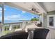 Inviting covered deck featuring comfortable seating and a stunning waterfront view, perfect for outdoor relaxation at 2081 Pointe Alexis Dr, Tarpon Springs, FL 34689