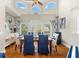 Bright dining room featuring hardwood floors, tall ceilings, and ample natural light from large windows at 2081 Pointe Alexis Dr, Tarpon Springs, FL 34689