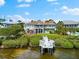 Waterfront home with a private dock and lush landscaping, offering serene coastal living at its finest at 2081 Pointe Alexis Dr, Tarpon Springs, FL 34689