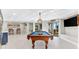 Game room featuring a pool table and with the backyard visible through the sliding doors at 2081 Pointe Alexis Dr, Tarpon Springs, FL 34689