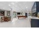 Spacious game room with a pool table, bar area, stylish lighting and easy access to the outdoors at 2081 Pointe Alexis Dr, Tarpon Springs, FL 34689