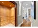 Hallway with a wooden elevator and views of the house with hardwood floors and white columns at 2081 Pointe Alexis Dr, Tarpon Springs, FL 34689