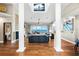 Elegant living room featuring comfortable seating, pillars, and a beautiful view of the water at 2081 Pointe Alexis Dr, Tarpon Springs, FL 34689
