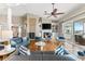 Elegant living room featuring stylish seating, a fireplace, and a sliding door to a balcony at 2081 Pointe Alexis Dr, Tarpon Springs, FL 34689