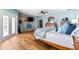 Cozy main bedroom with a decorative stone wall, hardwood floors, and modern amenities for a relaxing retreat at 2081 Pointe Alexis Dr, Tarpon Springs, FL 34689