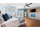 Sunlit main bedroom with a stone accent wall, hardwood floors, balcony access and ocean views through arched windows at 2081 Pointe Alexis Dr, Tarpon Springs, FL 34689