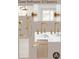 The bathroom features gold fixtures, white tile, vanity with white countertop, and modern lighting at 211 29Th Ave N, St Petersburg, FL 33704